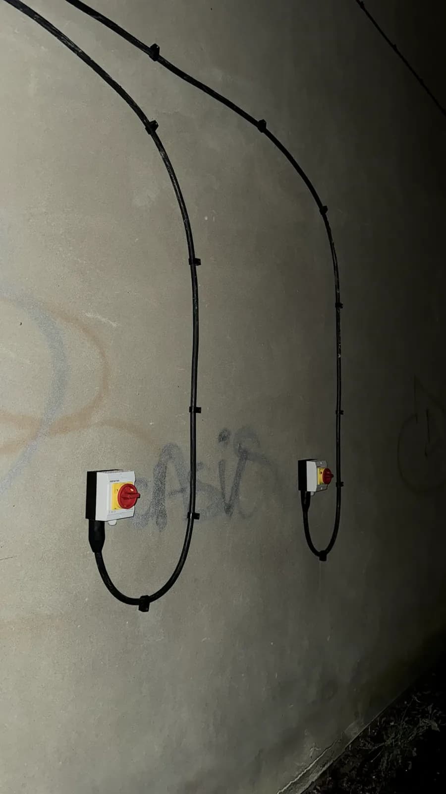 Rotary isolators with neat clipped cable runs on an external wall
