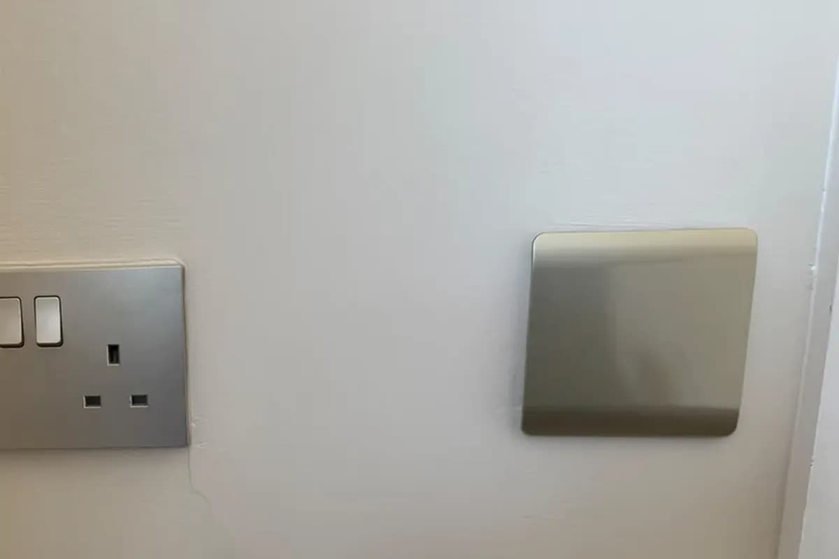 Brushed steel double socket and light switch we fitted in a London home